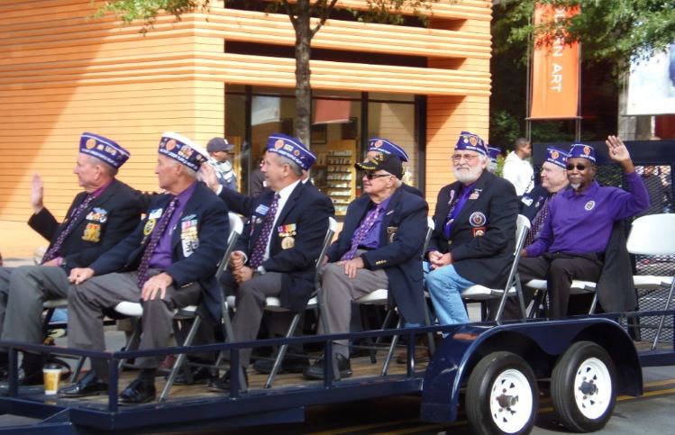 Veterans wearing purple hats and purple shirts 