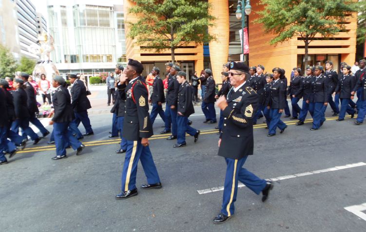 Veterans marching beside cadets.