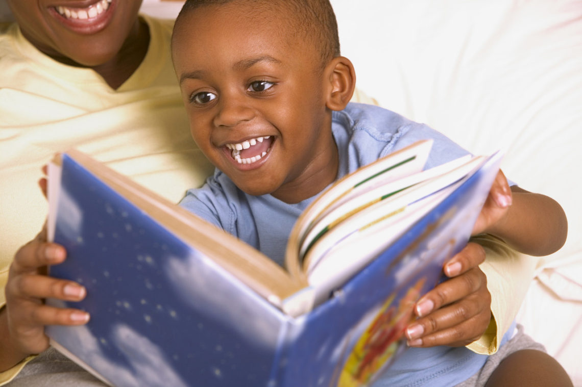 Happy boy reading book