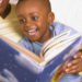 Happy boy reading book