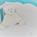 white teddy bear in crib