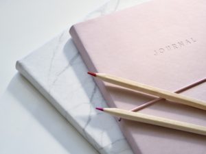 pink journal and pens