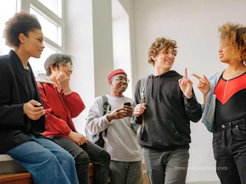 A group of young adults talking and smiling.