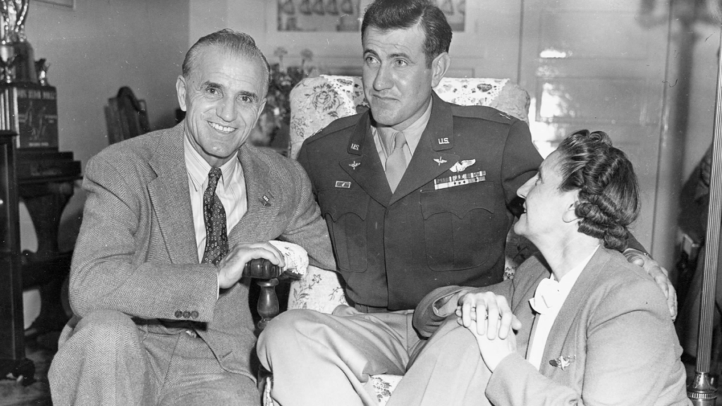 Black and white photo of Louis Zamperini with parents after WWII