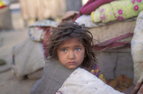 young, unclean girl with donated blankets