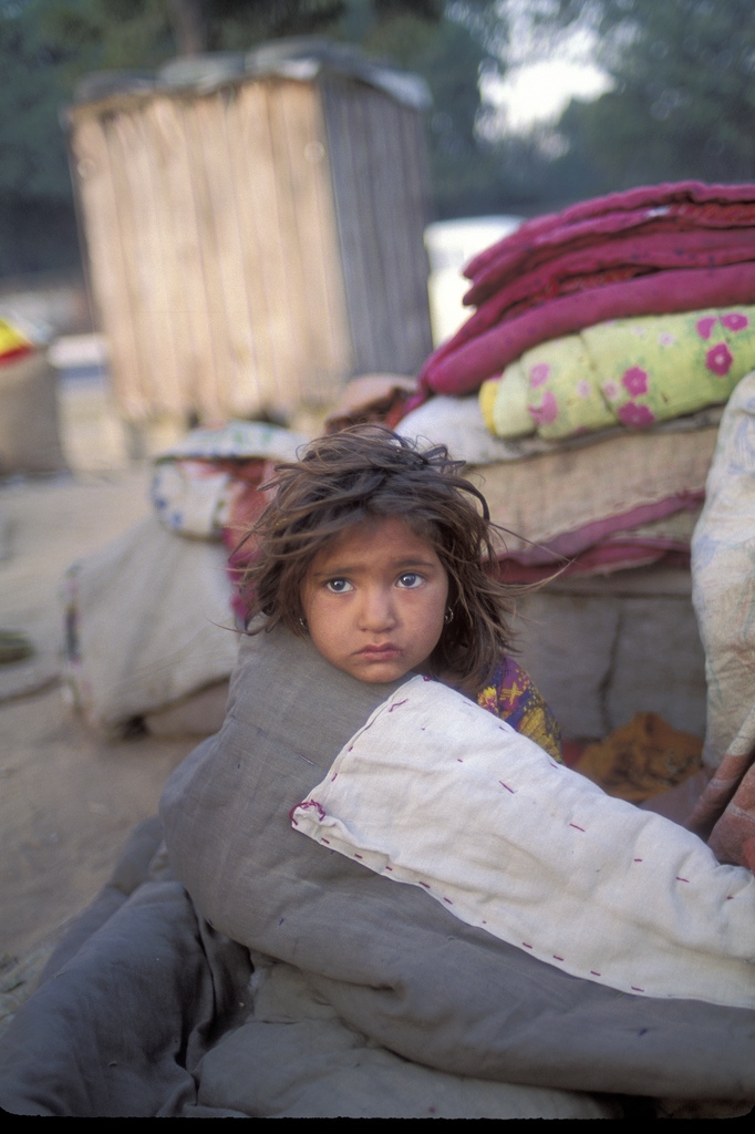 young, unclean girl with donated blankets