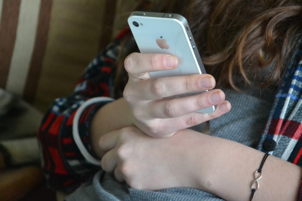 Girl holding a cell phone.