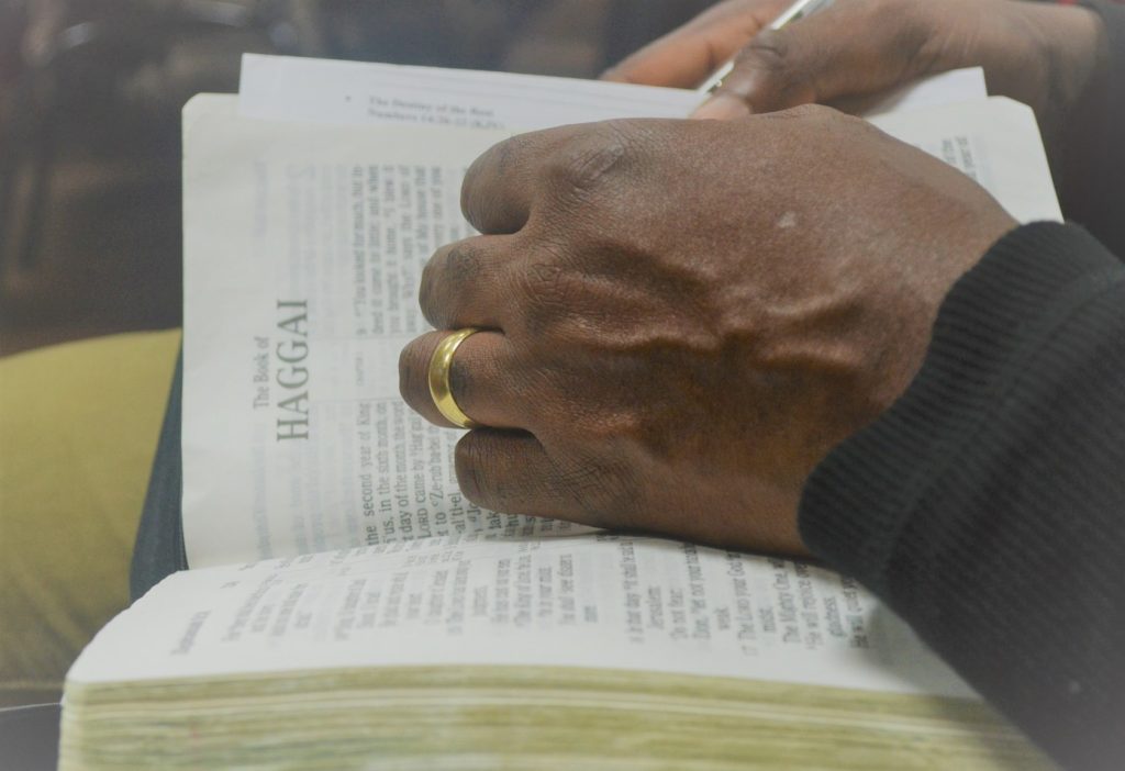 African American hand on Bible