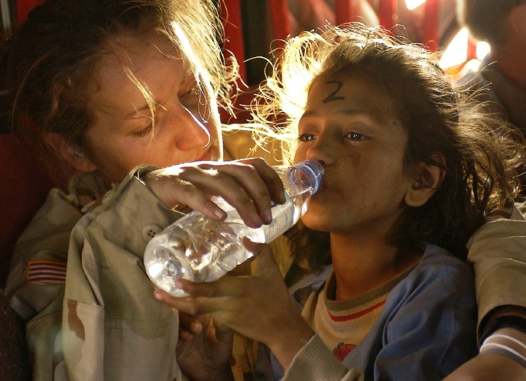Woman giving water to young girl. Talk to kids about God's presence.