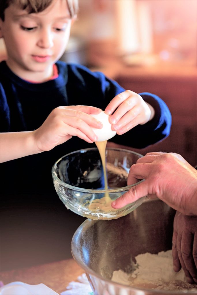 Cooking activities for kids- child cracking an egg