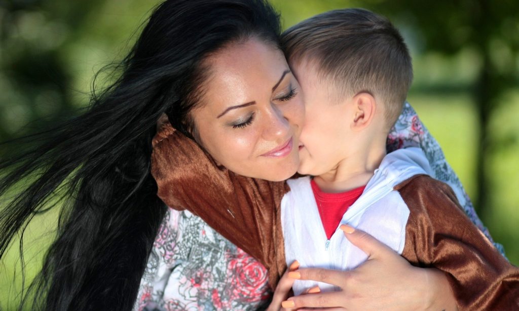 Talk to kids about God in the midst of natural disasters. (Mom hugging boy)