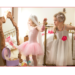 Two little girls playing in bride dress-up clothes.