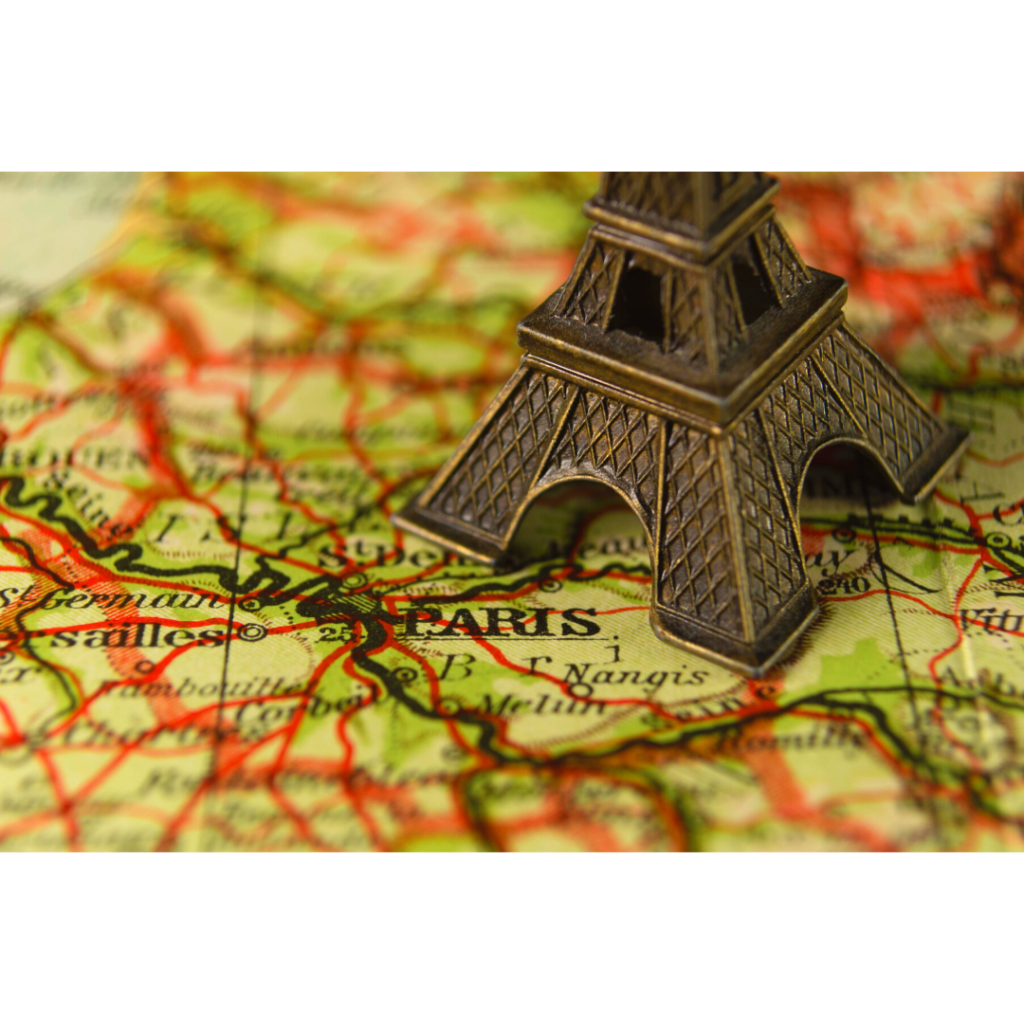 Photo of a map of Paris with a statue of the Eiffel Tower on top of the map.
Canva Photo, 2021.