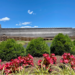 Sally Matheny's photo of the Ark Encounter. Shows huge wooden structure with hot pink flowers and green shrubs in the forefront. 2021.