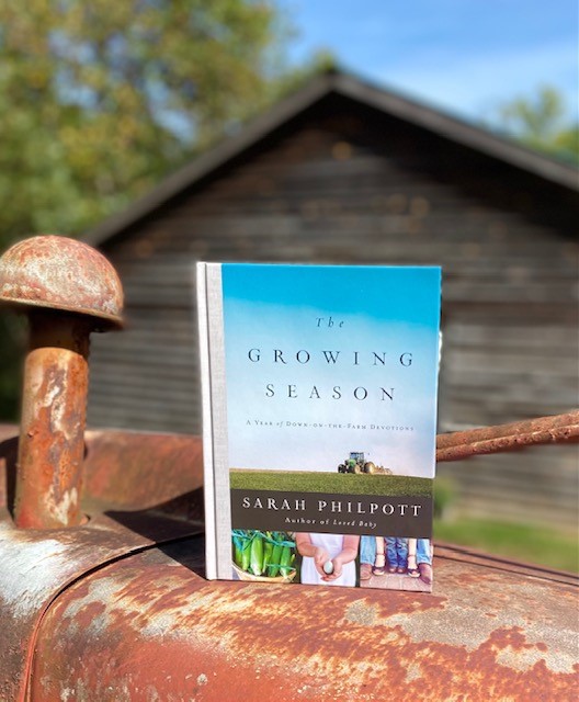 The Growing Season book sitting on Sally Matheny's old tractor.