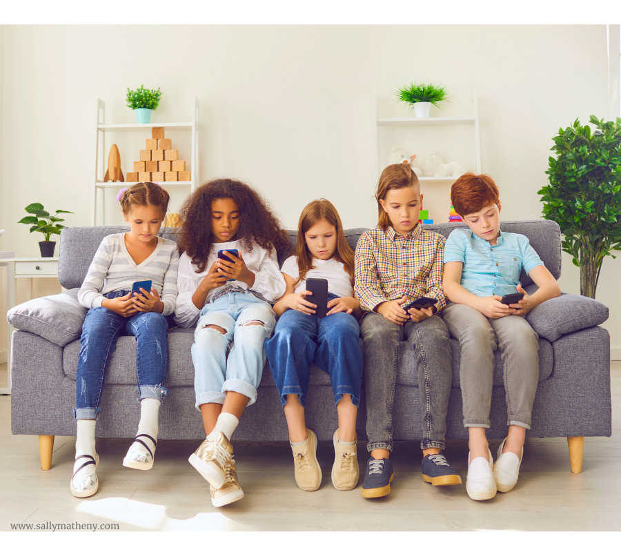 Shows five tweens sitting on a sofa  engaging in social media on their devices.