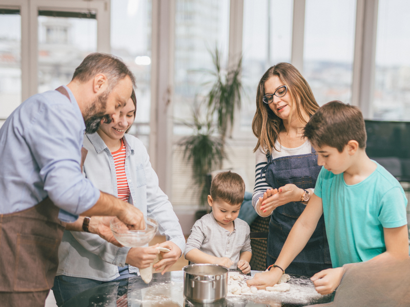 Shows family of five baking bread for neighbors during the Easter season.